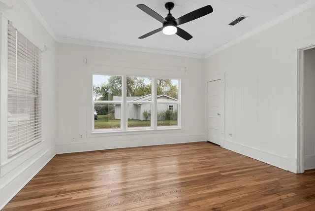 wooden floor in an empty room with a window