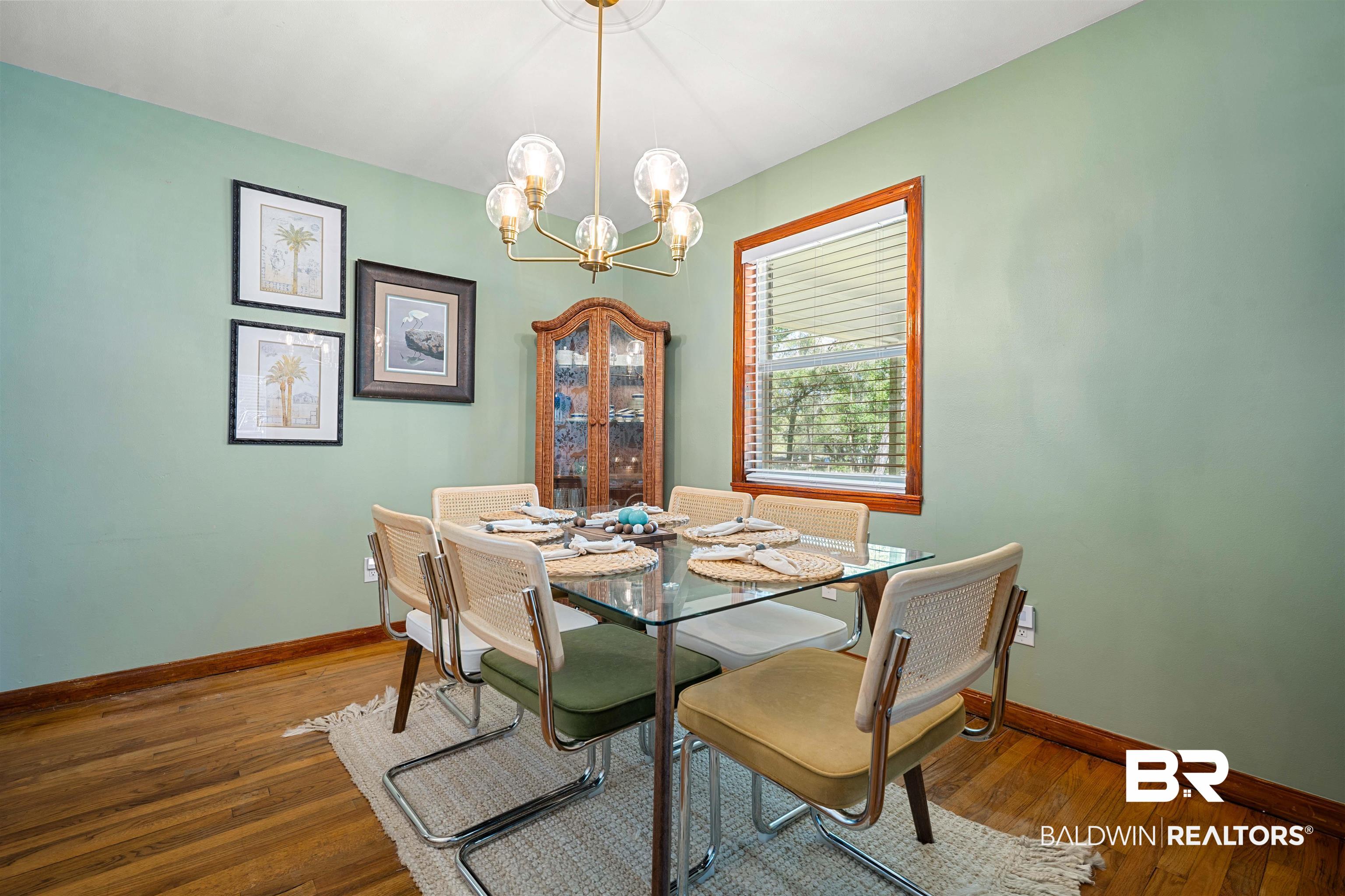 672 Tarawa Drive Mobile, AL 36609 - Photo 14 of 26 Dining room with wood-type flooring and suspended lighting