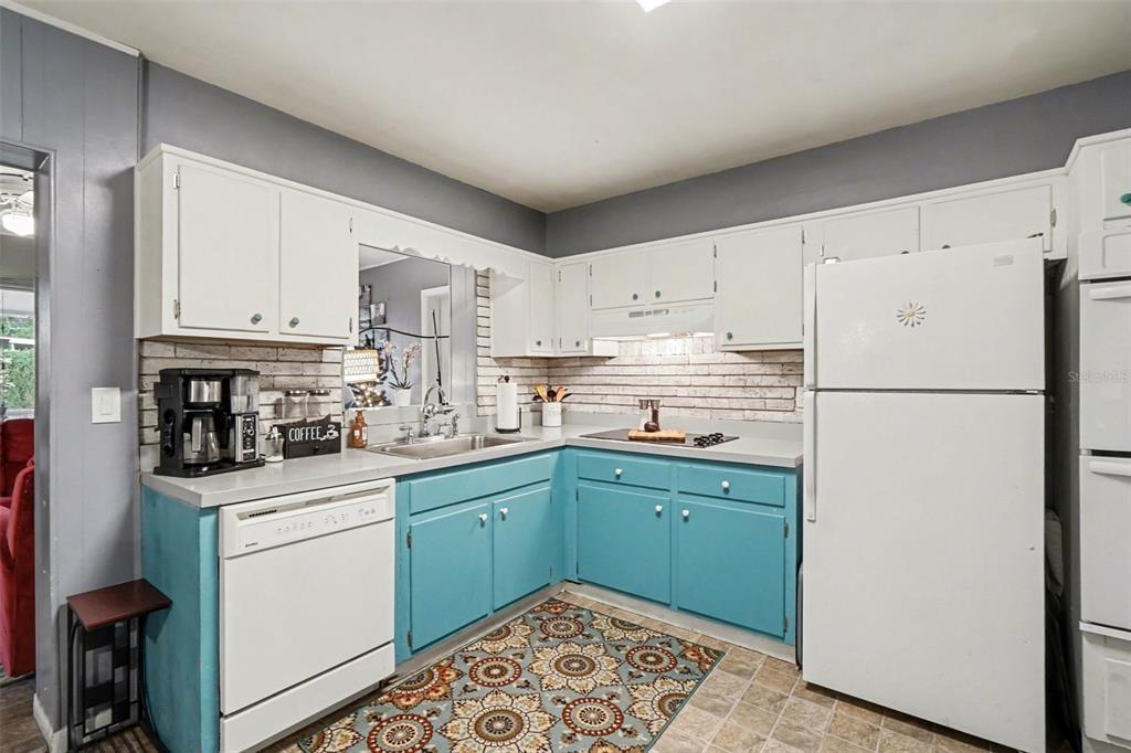 2300 Lake Road Fern Park, FL 32730 - Photo 12 of 25 a kitchen with stainless steel appliances granite countertop a refrigerator sink and white cabinets