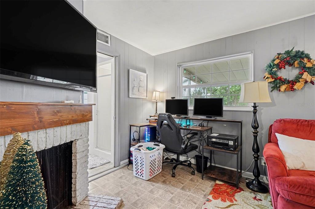 2300 Lake Road Fern Park, FL 32730 - Photo 16 of 25 a living room with furniture a flat screen tv and a fireplace