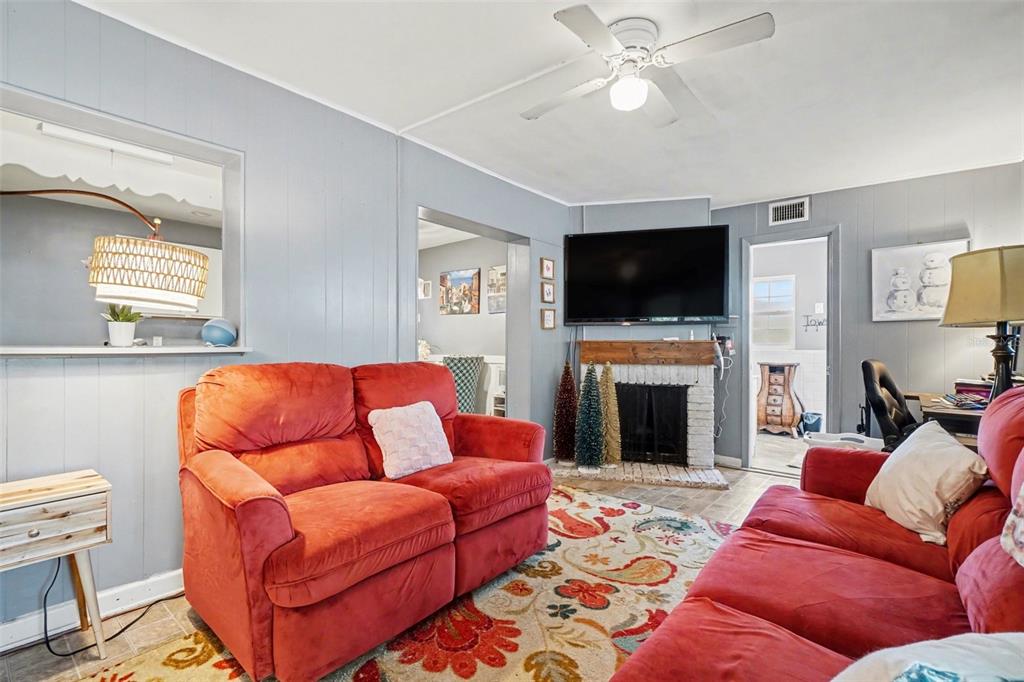 2300 Lake Road Fern Park, FL 32730 - Photo 18 of 25 a living room with furniture a flat screen tv and a fireplace