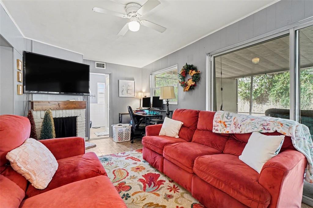 2300 Lake Road Fern Park, FL 32730 - Photo 19 of 25 a living room with furniture a fireplace and a flat screen tv