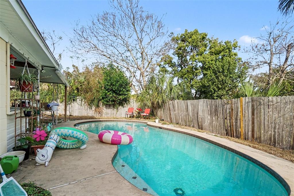 2300 Lake Road Fern Park, FL 32730 - Photo 25 of 25 a backyard of a house with table and chairs and potted plants