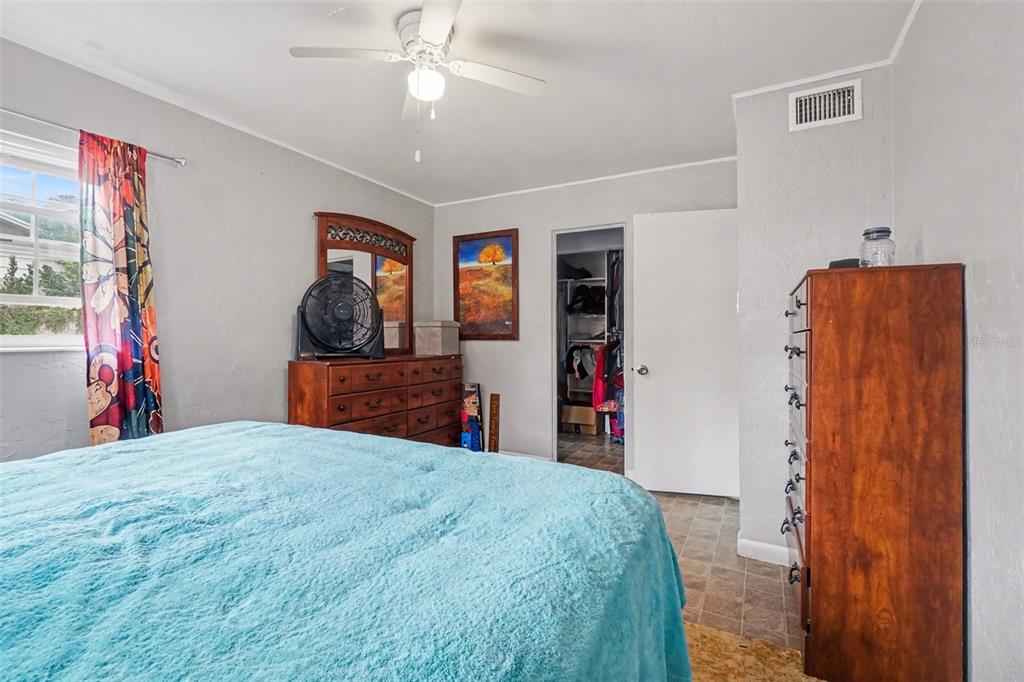 2300 Lake Road Fern Park, FL 32730 - Photo 5 of 25 a bedroom with a large bed and a chandelier