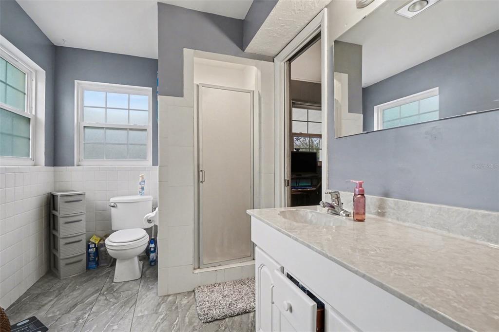 2300 Lake Road Fern Park, FL 32730 - Photo 7 of 25 a bathroom with a granite countertop sink a toilet and shower