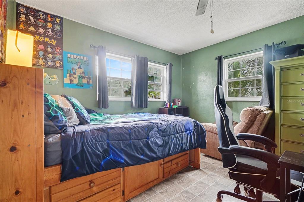 2300 Lake Road Fern Park, FL 32730 - Photo 8 of 25 a bedroom with a bed chair and window