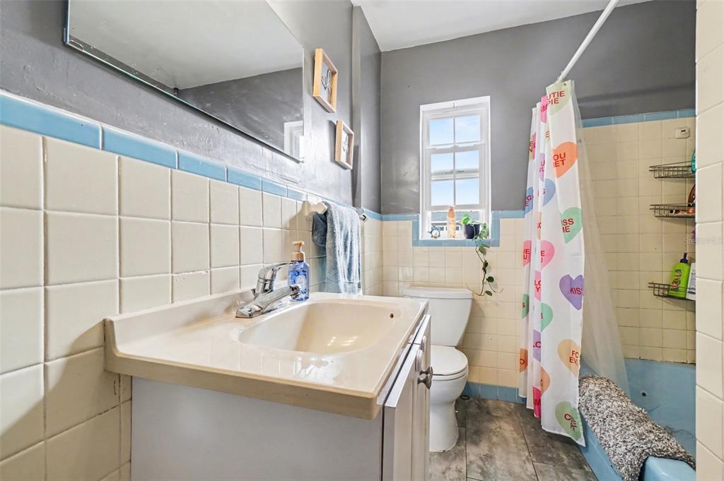 2300 Lake Road Fern Park, FL 32730 - Photo 9 of 25 a bathroom with a sink a toilet and shower curtain