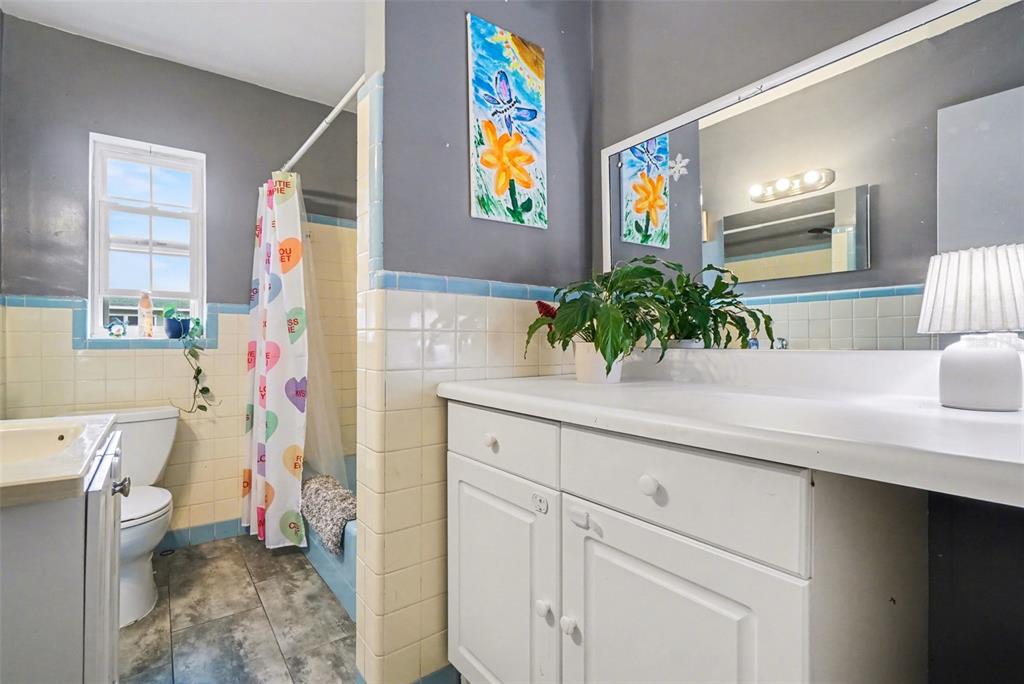 2300 Lake Road Fern Park, FL 32730 - Photo 10 of 25 a bathroom with a sink a toilet and a large mirror