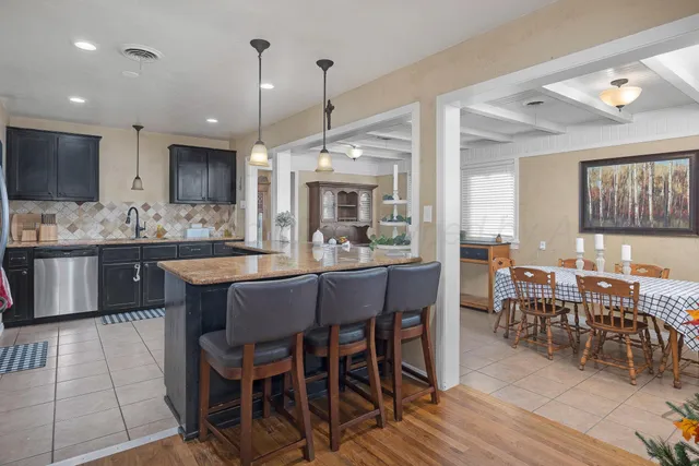 a large kitchen with a table and chairs