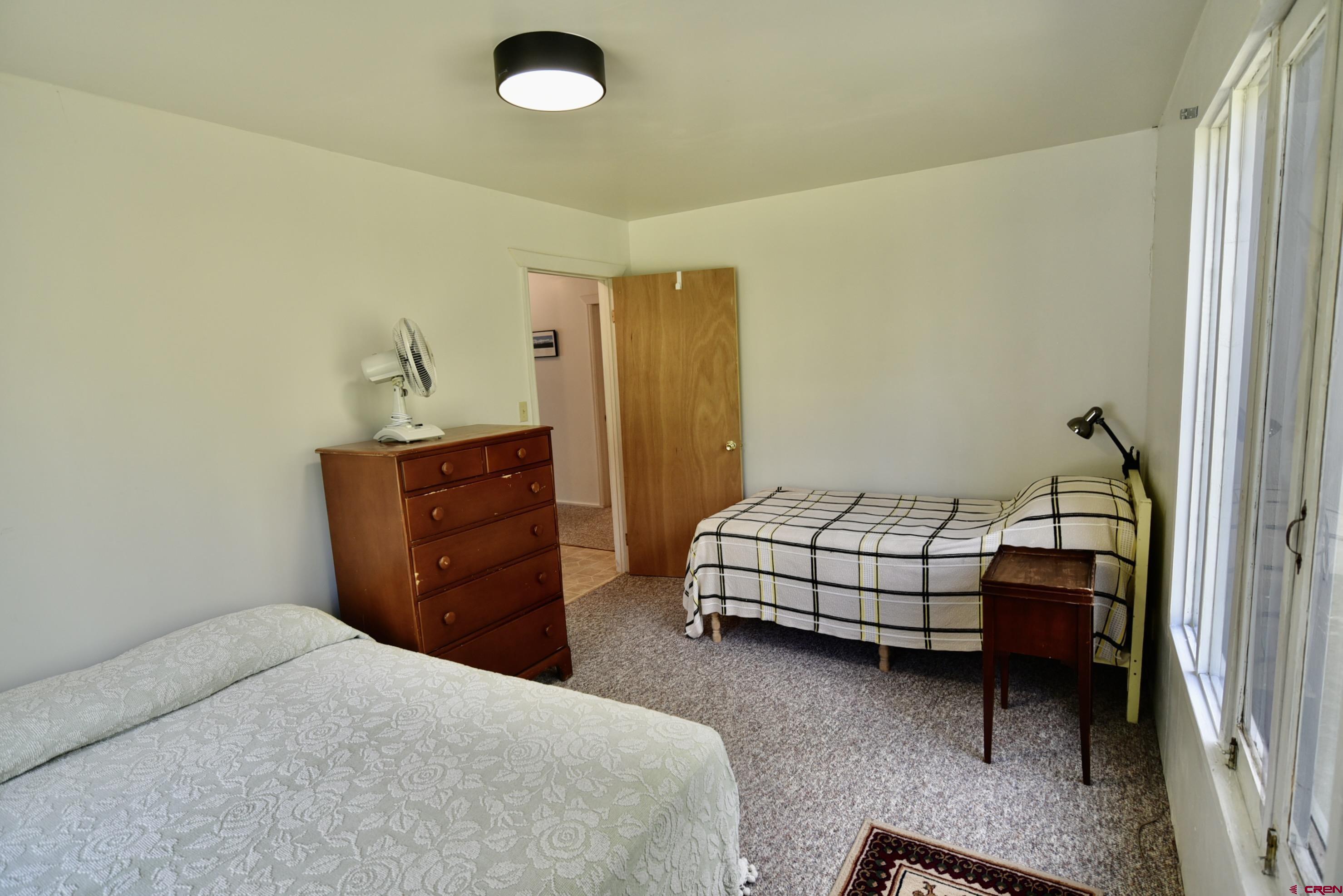 704 Hampton Road Montrose, CO 81220 - Photo 20 of 45 a bedroom with a bed and cabinets