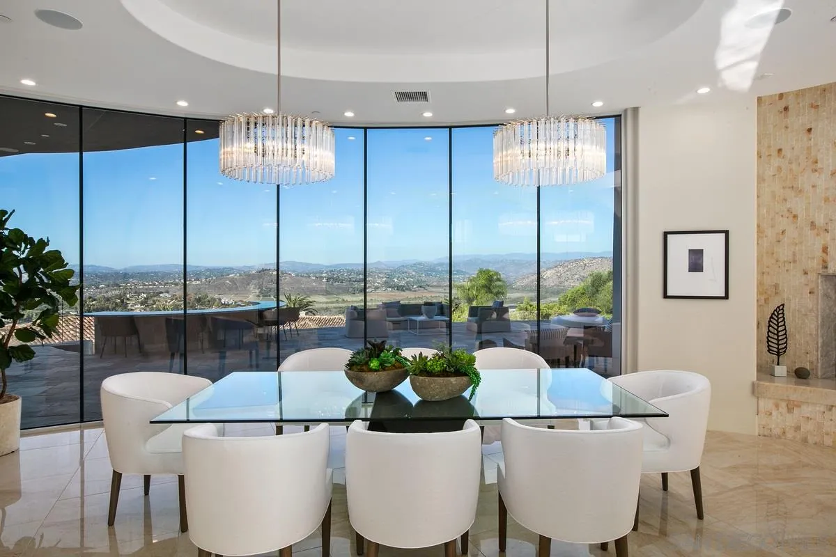 13220 Highlands Ranch Road Poway, CA 92064 - Photo 4 of 12 a dining room with furniture a chandelier and kitchen view