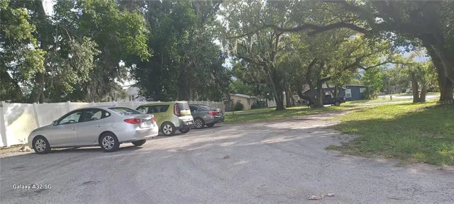 a view of a yard with car parked