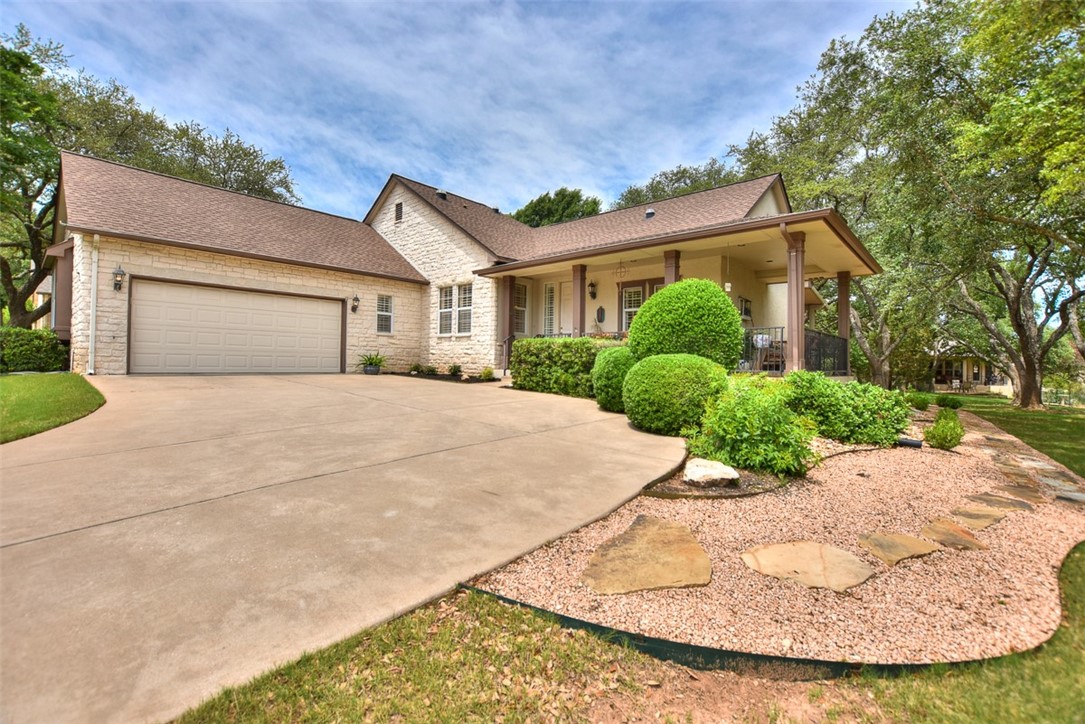 a view of a house with a yard and potted plants
