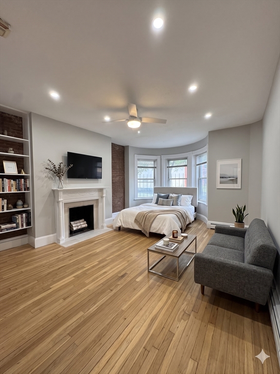 198 St Botolph Street, Unit 2 Boston, MA 02115 - Photo 2 of 10 a spacious bedroom with a bed and a couch
