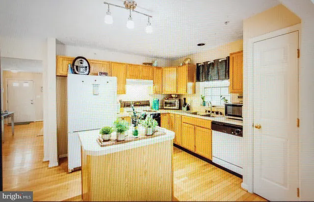 a kitchen with a refrigerator and a stove