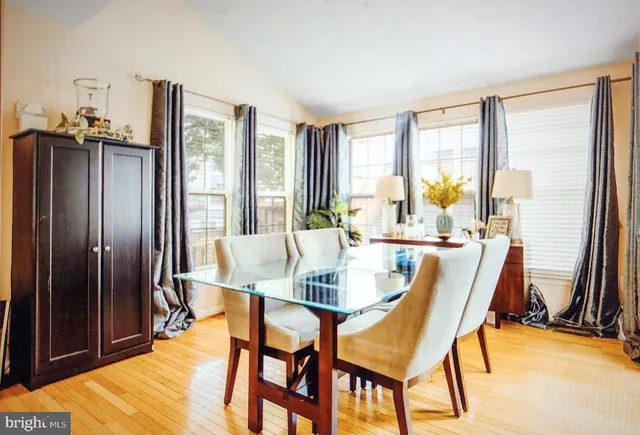 a dining room with furniture and a window