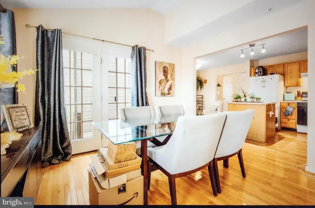 a dining room with furniture and a floor to ceiling window