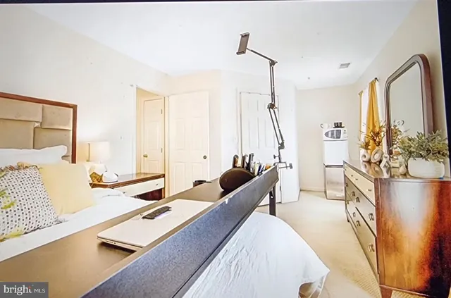 a bedroom with furniture and a large window