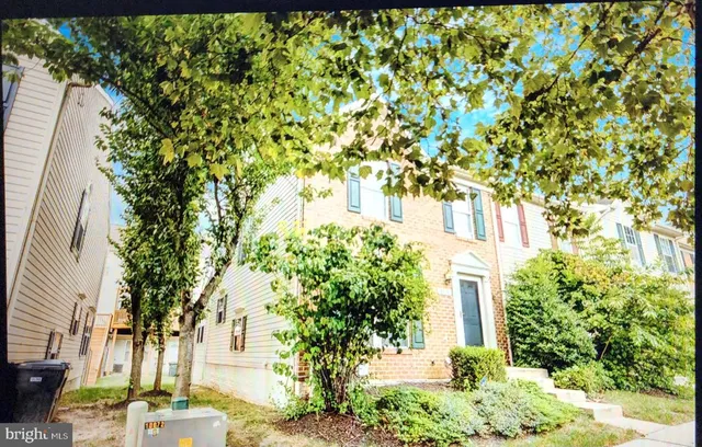 a view of a pathway of a house with a tree