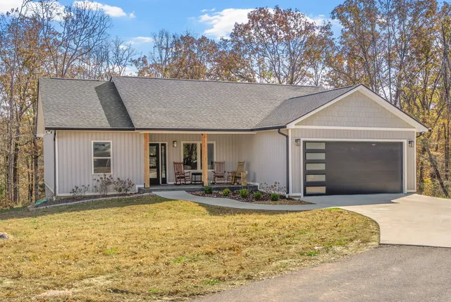 a view of a house with pool and chairs
