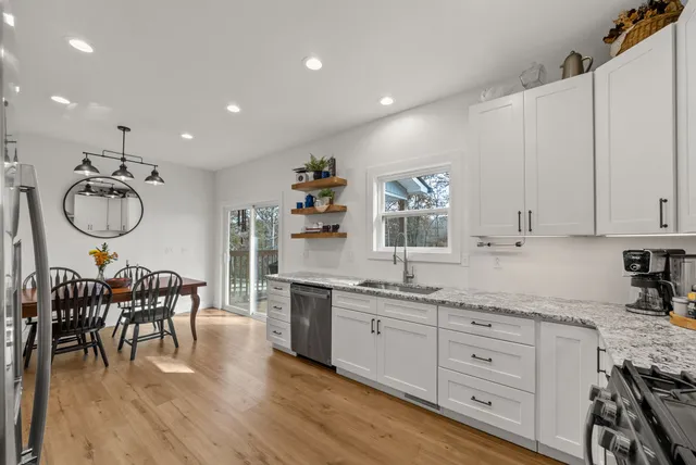 a kitchen with sink cabinets and dining table