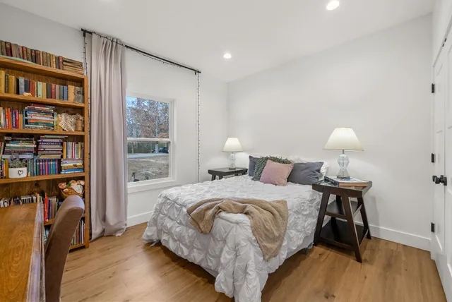 a bedroom with a bed and a book shelf