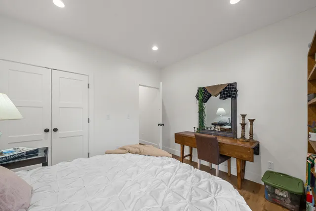 a bedroom with a bed and a table in it