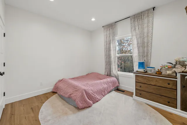 a bedroom with a bed and a window