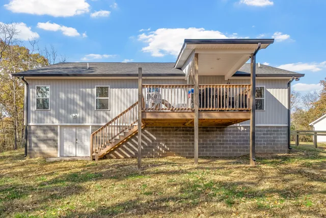 a view of a house with a small yard and wooden floor