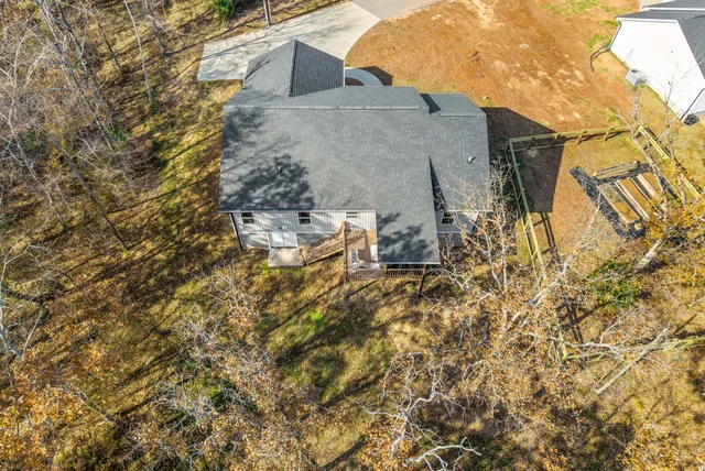 a backyard of a house with table and chairs