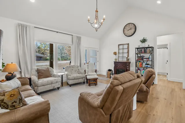 a living room with furniture a fireplace and a large window