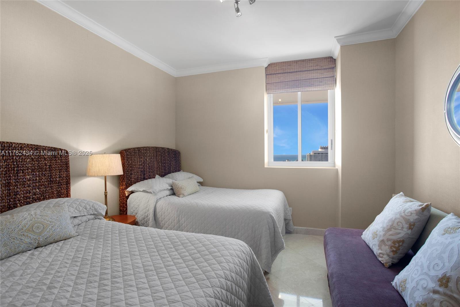 4775 Collins Avenue, Unit 4005 Miami Beach, FL 33140 - Photo 17 of 26 a bedroom with a bed and window