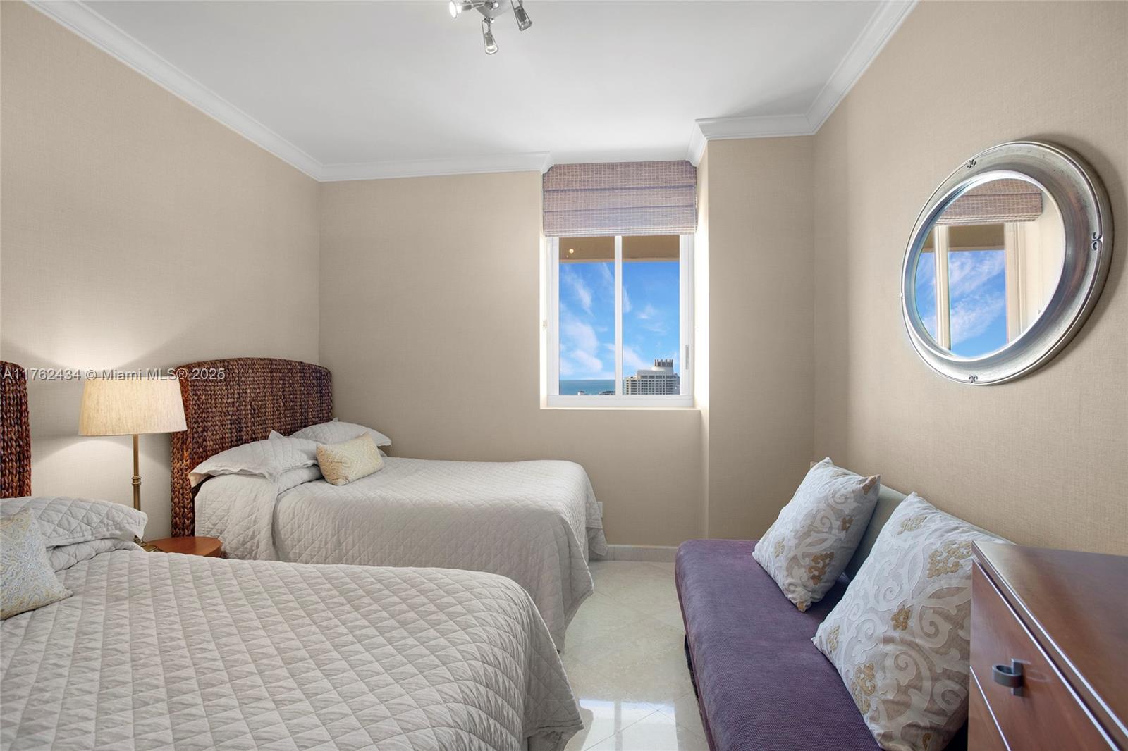 4775 Collins Avenue, Unit 4005 Miami Beach, FL 33140 - Photo 18 of 26 a bedroom with a bed and a mirror