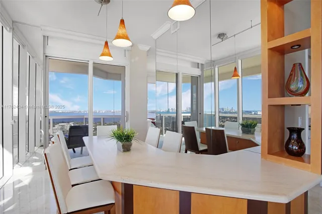 a dining room with furniture and a large window