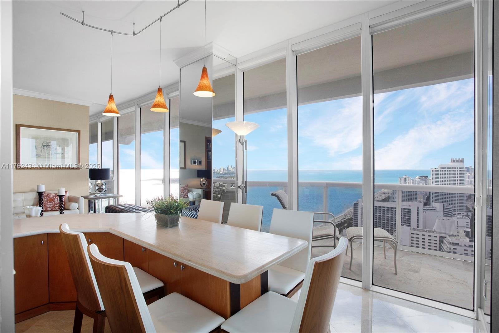 4775 Collins Avenue, Unit 4005 Miami Beach, FL 33140 - Photo 7 of 26 a dining room with furniture and a floor to ceiling window