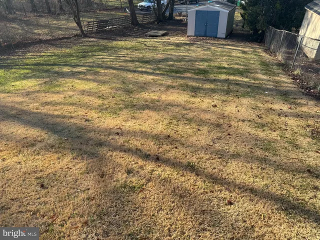 a view of a hallway with wooden floor and stairs