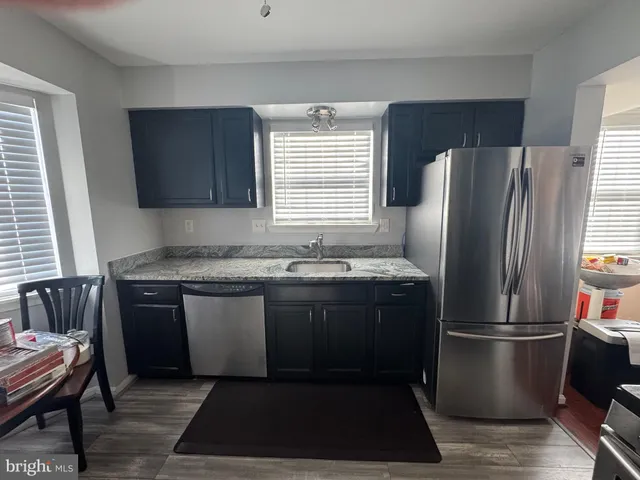 a view of a room with a table and chairs