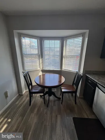a view of a room with furniture window and wooden floor