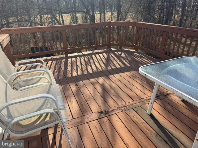 a swimming pool with an outdoor seating and lake view
