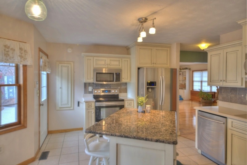 148 Eakle Road Staunton, VA 24401 - Photo 32 of 49 a kitchen with stainless steel appliances granite countertop a refrigerator oven stove a sink dishwasher and white cabinets with wooden floor