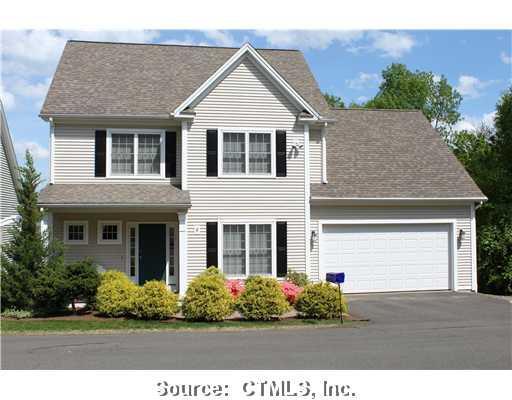 8 Centerwood Road, Unit 8 Burlington, CT 06013 - Photo 1 of 1 a front view of a house with a garden