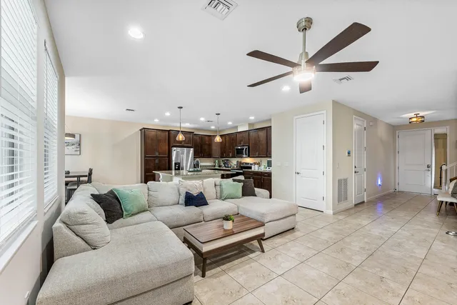 a living room with furniture and kitchen view