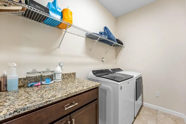a kitchen with a sink a stove and cabinets