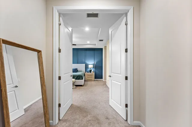 a view of a hallway with couch and a cabinet in a room
