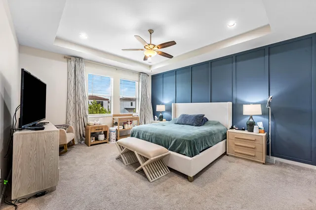 a spacious bedroom with a bed and glass wall