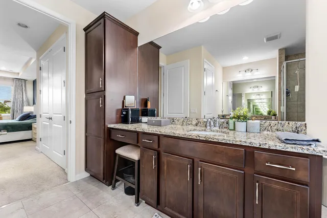 a bathroom with a granite countertop sink mirror and double