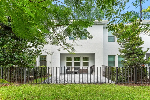 a front view of a house with a garden and deck
