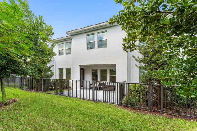 a view of a house with a backyard and a garden