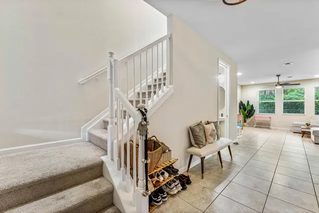 a view of staircase with furniture and a window