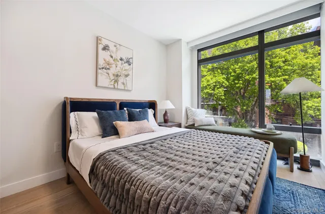 a bedroom with a large bed and a window